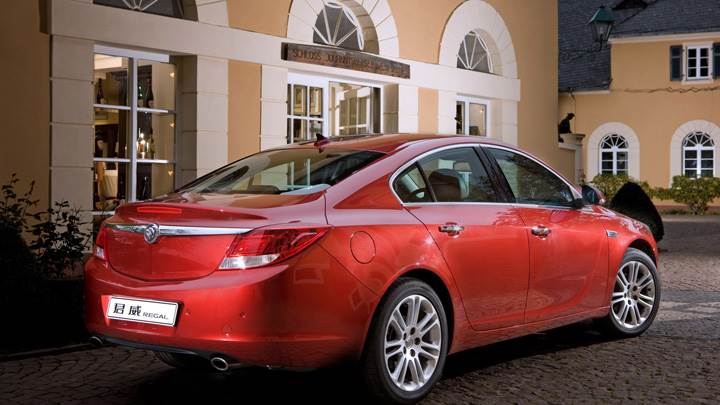 Side Back Pose Of 2008 Buick Regal 2.0 Turbo In Red Outside House